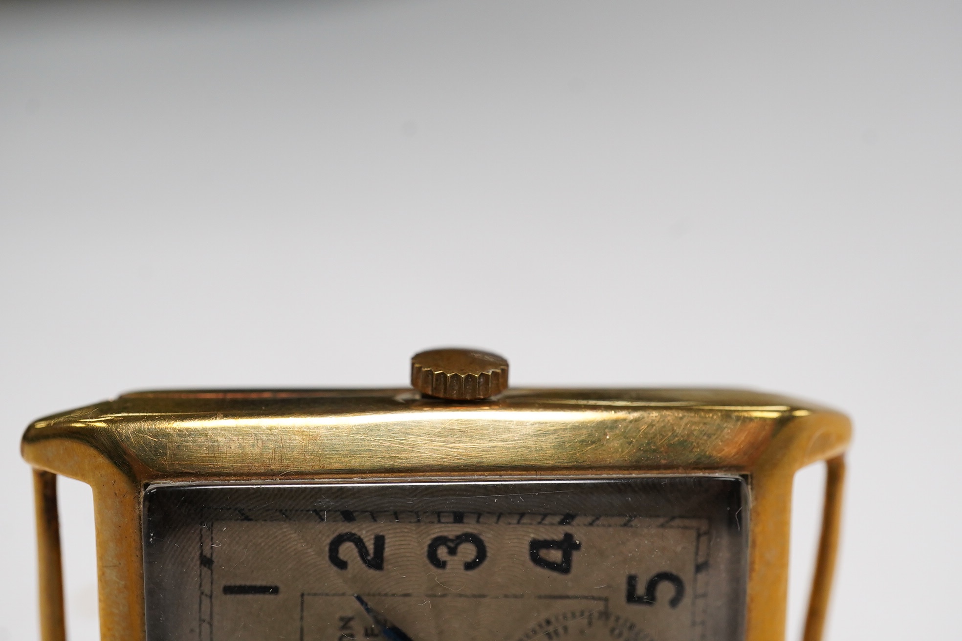 A gentleman's 9ct gold rectangular dial, manual wind wrist watch, retailed by Bravington, case diameter 26mm, no strap. Condition - poor to fair